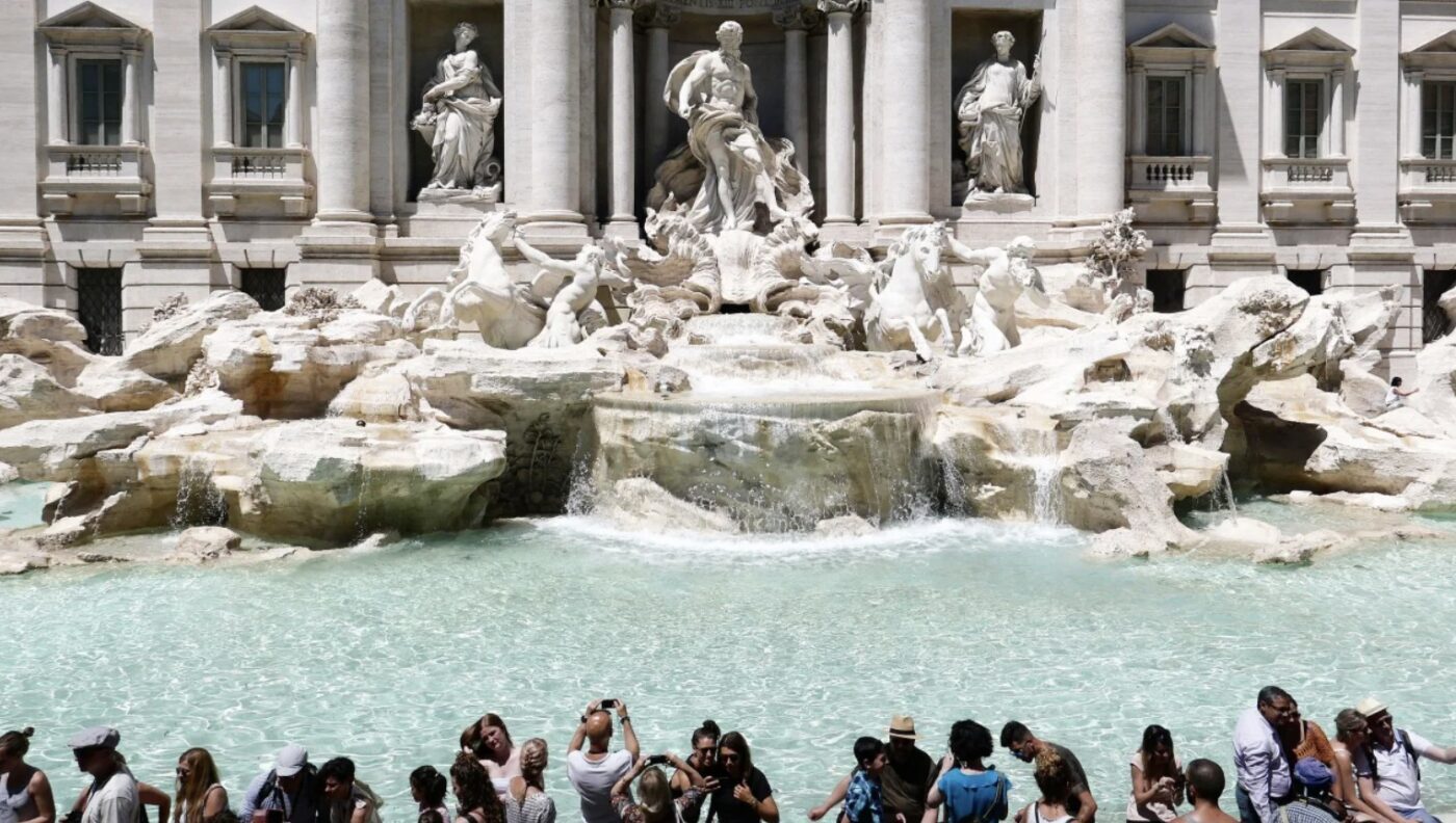 Shows Tourist Climbing into Rome’s Trevi Fountain to Fill Up Water Bottle